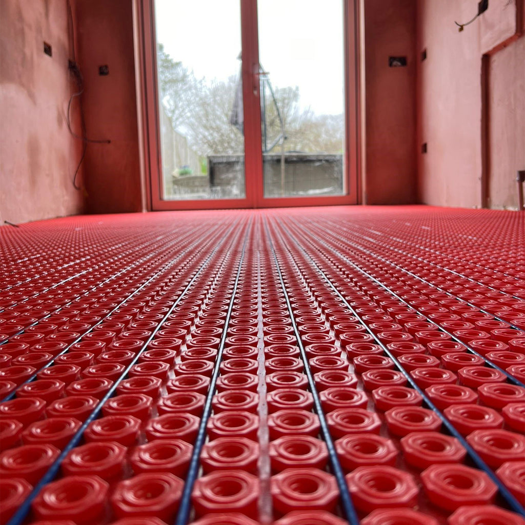 Electric underfloor heating cable being installed in a decoupling membrane