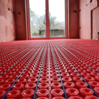 Electric underfloor heating cable being installed in a decoupling membrane