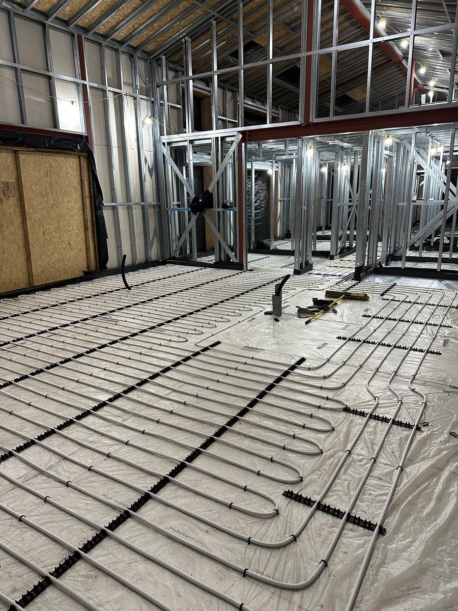 Underfloor heating pipework across a steel-framed property